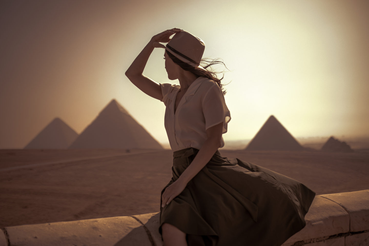 Solo Female Explorer Looking into the Sunrise on the Giza Pyramids