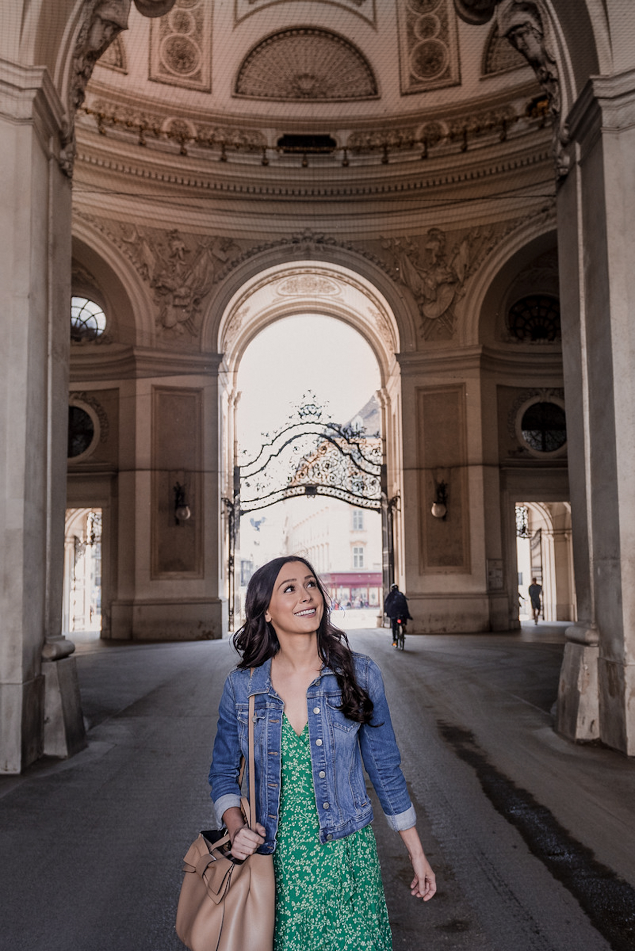Solo female traveler smiling while walking through City Center, Vienna, Austria