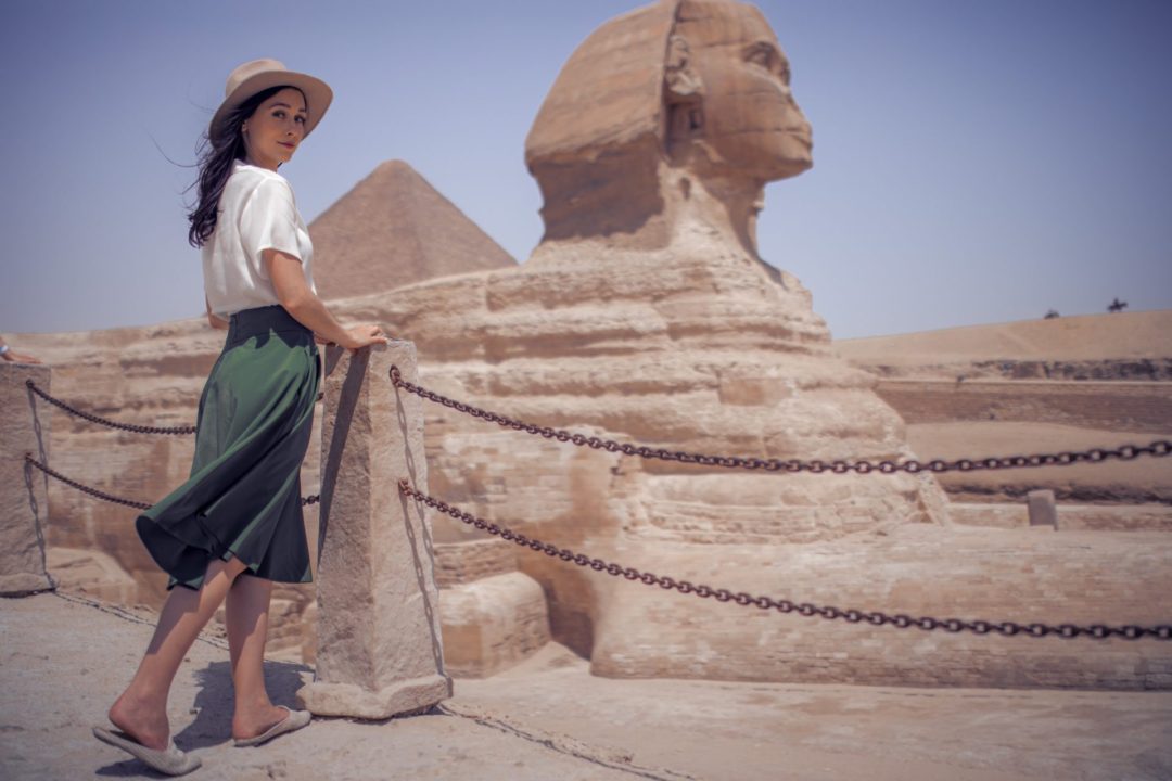 Jordan Gassner wearing an Indiana Jones inspired outfit while standing alongside the Sphinx in Giza, Egypt