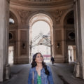 Solo female traveler smiling while walking through City Center, Vienna, Austria