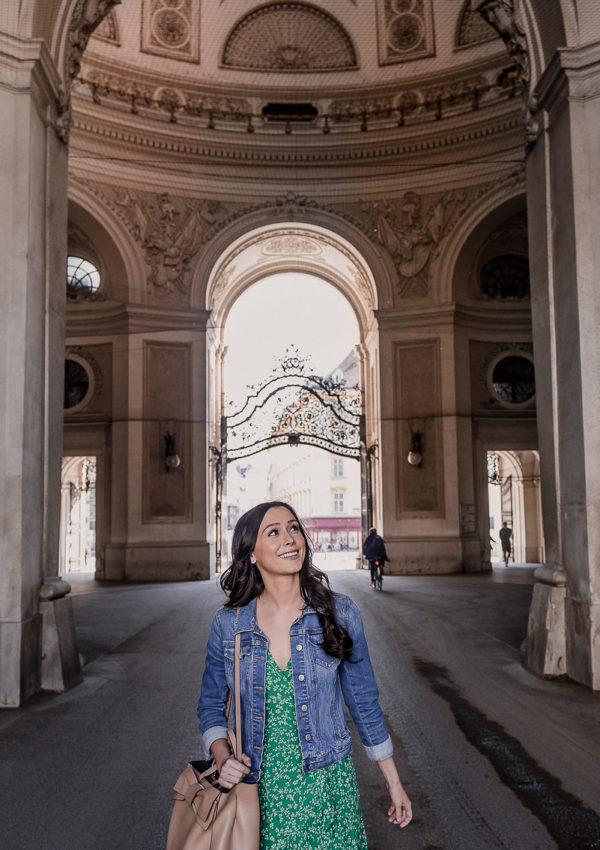 Solo female traveler smiling while walking through City Center, Vienna, Austria