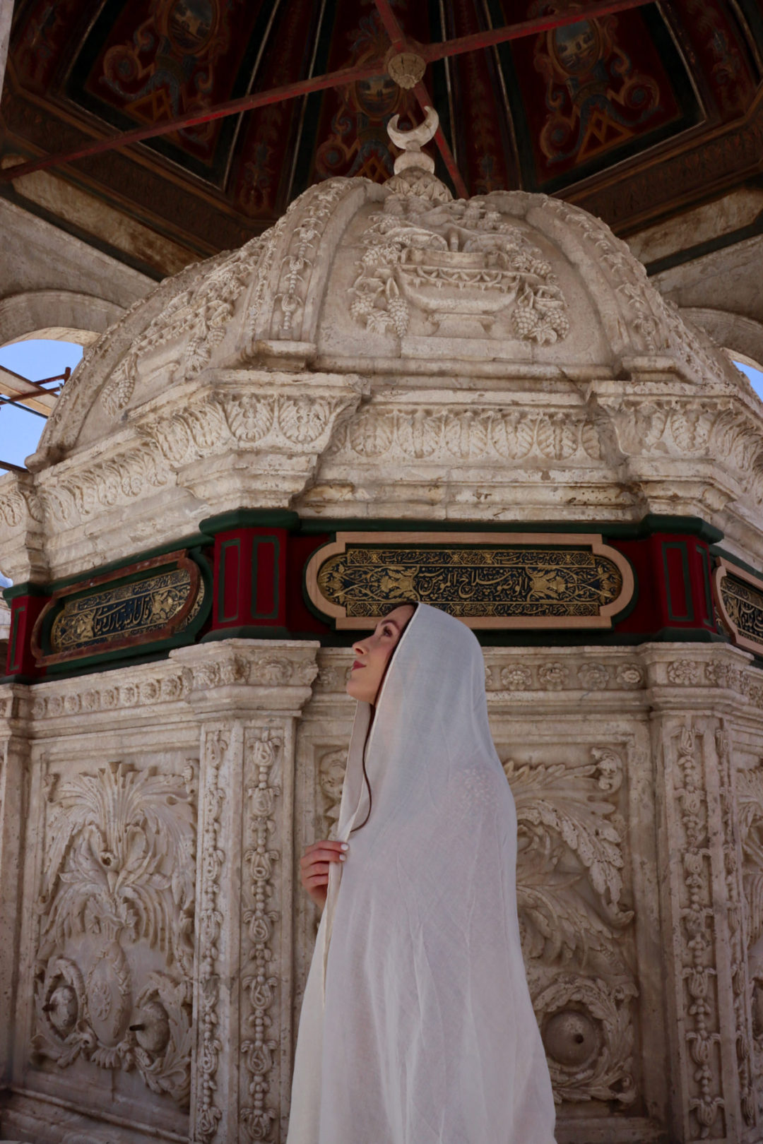 Jordan Gassner looking up at the ceiling of the sahn at the Great Mosque of Muhammad Ali Pasha in Cairo, Egypt