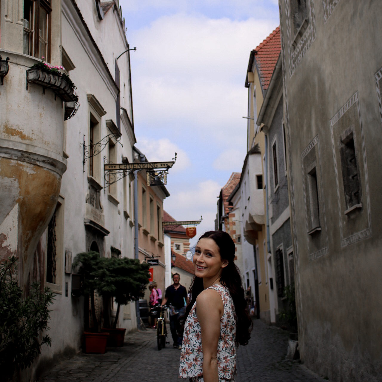 Jordan Gassner standing and smiling on the historic main street of Durnstein, Austria