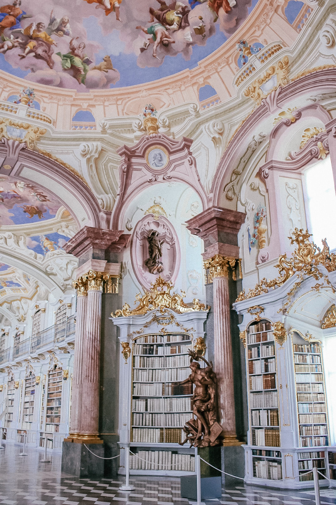The pink, blue and white baroque architecture at Admont Abbey, the largest monastic library in the world.