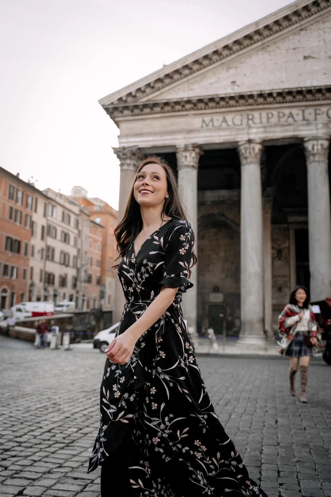 Travel Blogger Jordan Gassner smiling while walking in front of the Pantheon in Rome, Italy