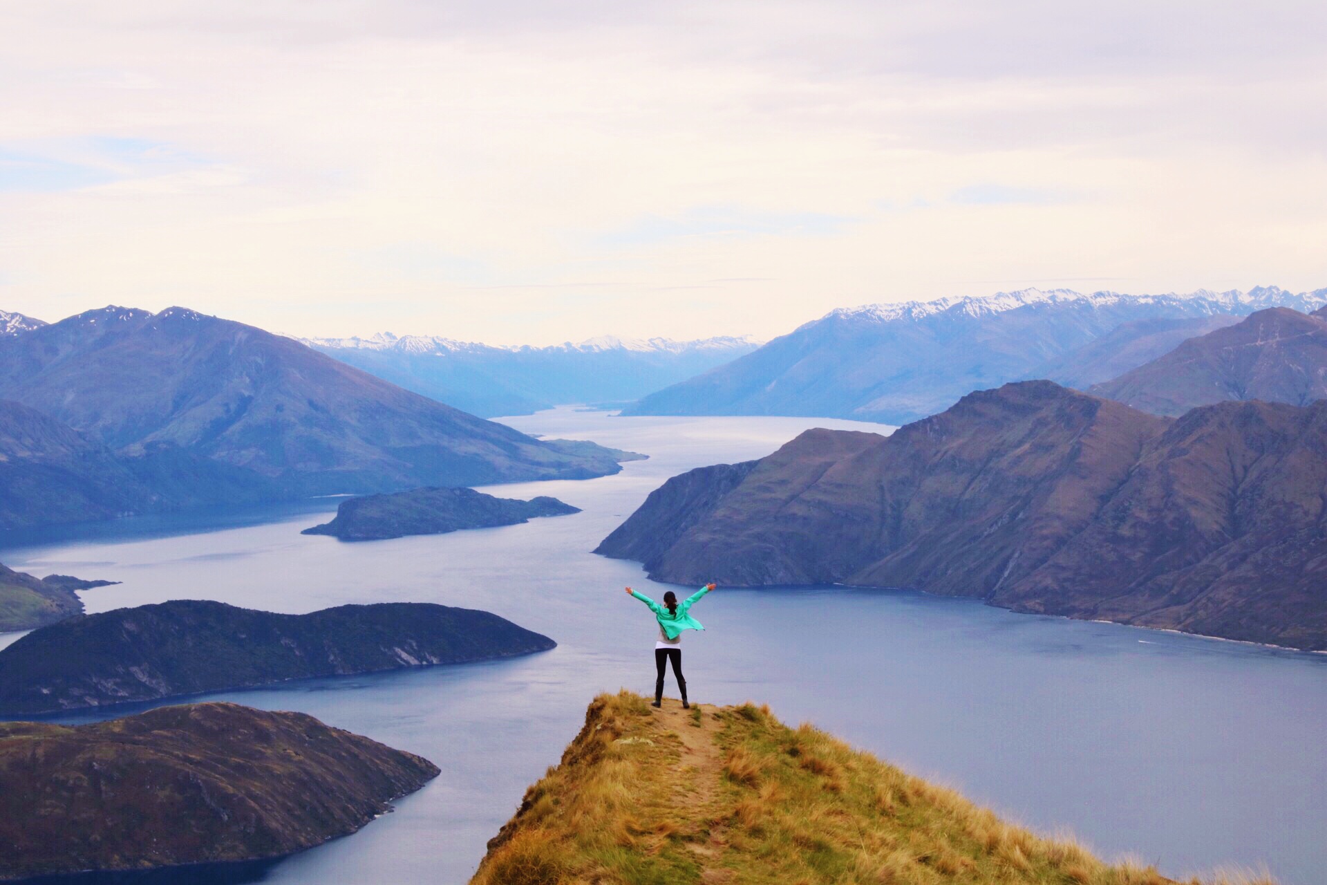 Travel Blogger Jordan Gassner standing on top of Roy's Peak in Wanaka, New Zealand