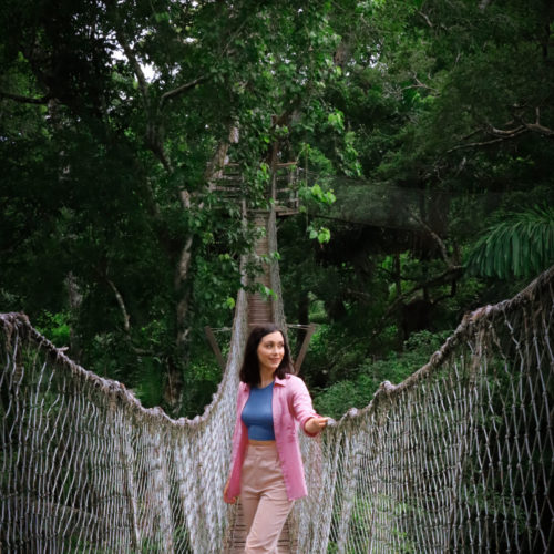 Travel Blogger Jordan Gassner looking out over one of the rope bridges along Inkaterra Reserva Amazonica's Canopy Walkway in the Peruvian Amazon