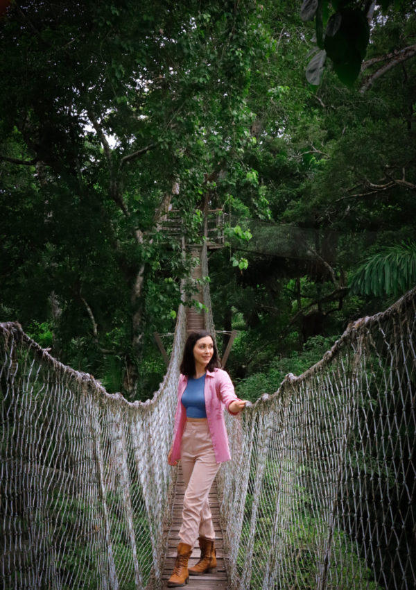 Travel Blogger Jordan Gassner looking out over one of the rope bridges along Inkaterra Reserva Amazonica's Canopy Walkway in the Peruvian Amazon