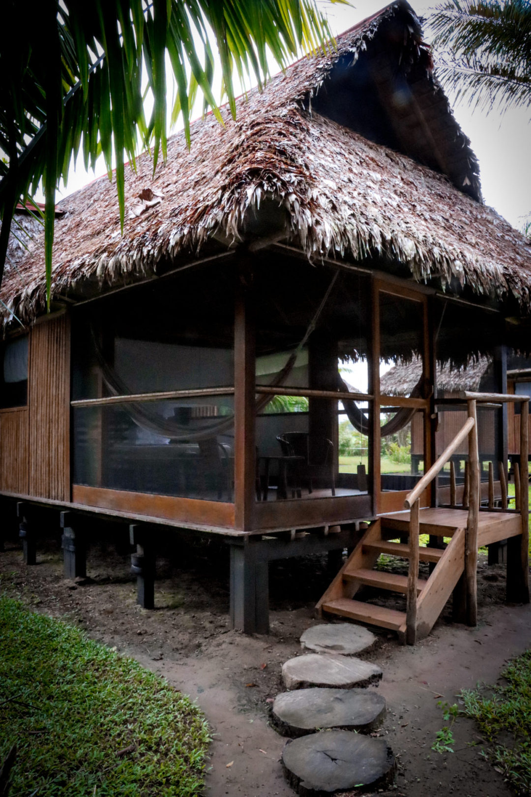Wooden Thatched-Roof Bungalow during the day at Inkaterra Reserva Amazonica, Puerto Maldonado, Peru
