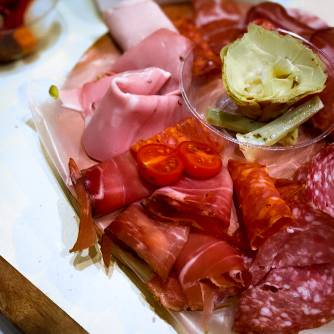 Close-up on a dairy-free plate of cured meats and artichoke from Bottega Trevi in Rome
