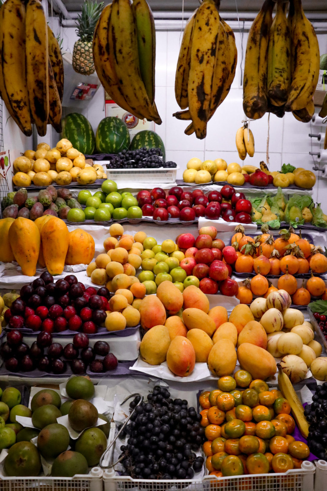 Assortment of colorful Peruvian fruits at a local market stand inside Mercado 1 de Surquillo in Lima, Peru