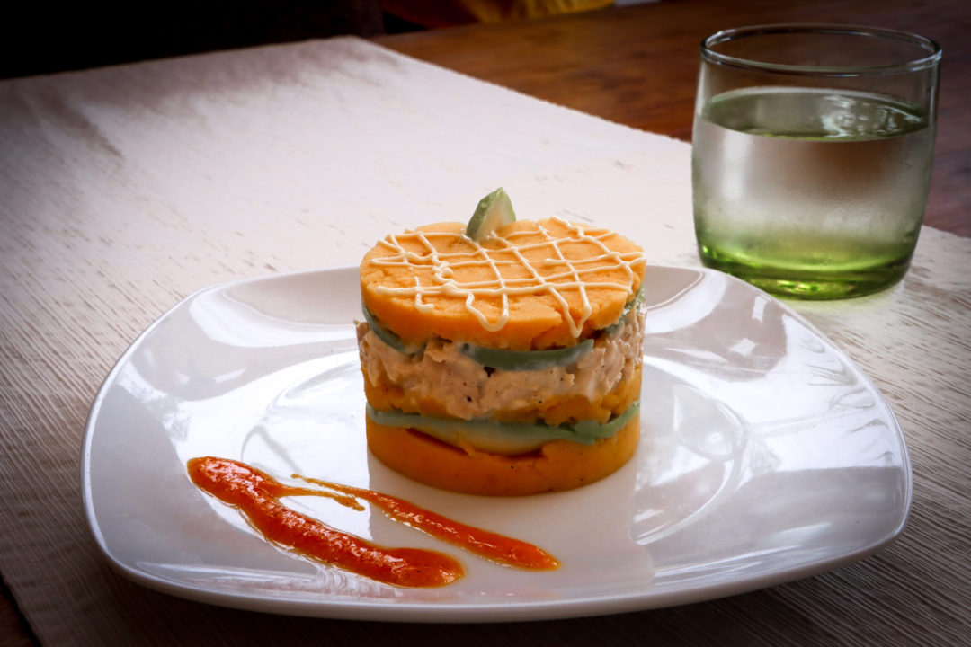 Student-made causa on a white plate from SkyKitchen Cooking School in Lima, Peru