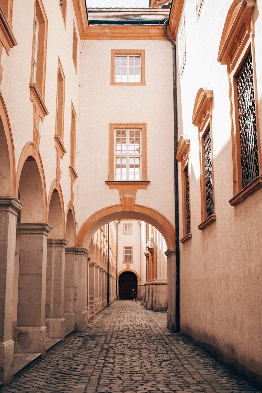 Interior Courtyard Cobblestone Corridor outside the Yellow-Painted Melk Abbey in Wachau, Austria