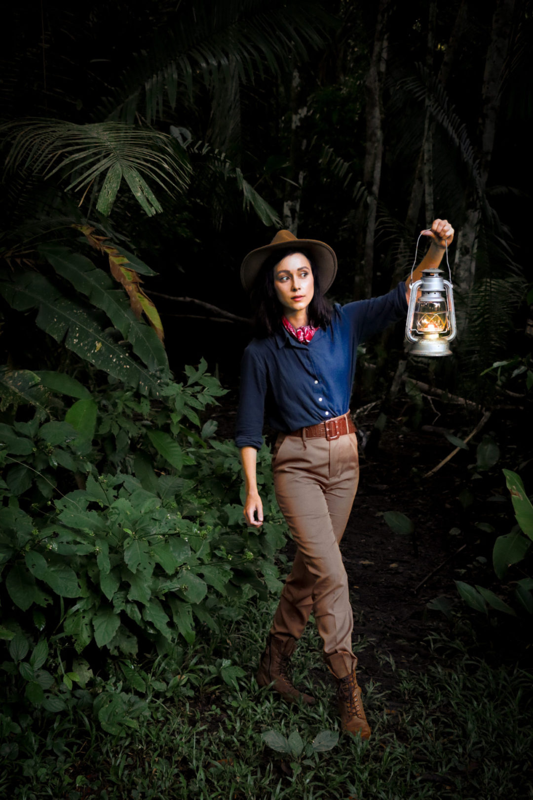 Travel Blogger Jordan Gassner wearing a Jungle Cruise inspired outfit and vintage lantern while traversing the Peruvian Amazon