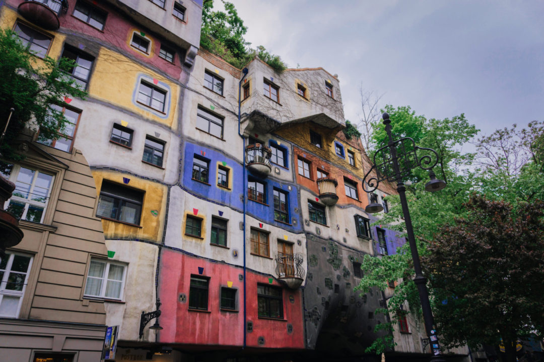 Vienna Travel Guide: Hundertwasserhaus Apartment Complex ignores traditional architectural design in favor of wavy lines and bright colors and interesting shapes.