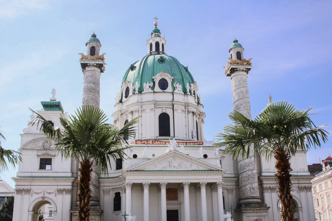 Vienna Travel Guide: Karlskirche stands proud under the blue spring sky in Vienna, Austria