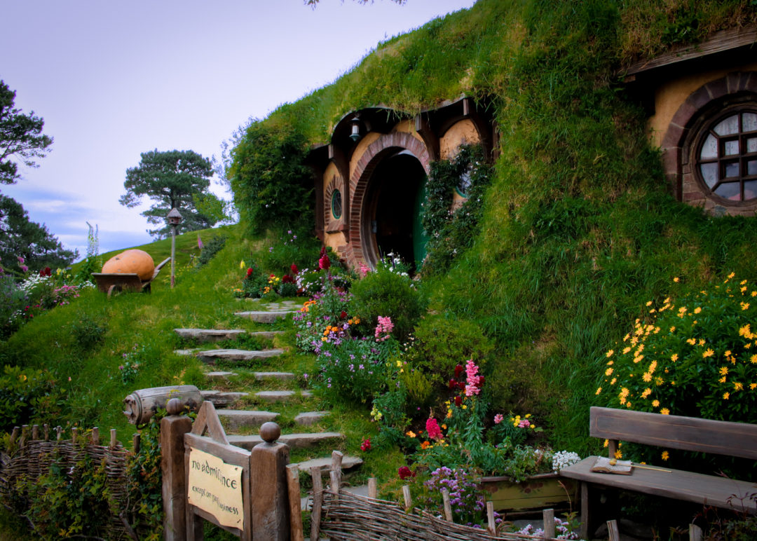 The slightly ajar green door of Frodo and Bilbo's Bag End atop the hill in Hobbiton New Zealand