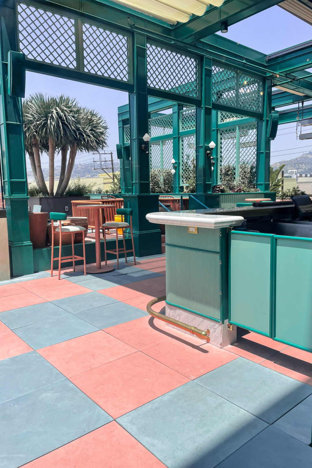 The Pink, Coral and Turquoise Design near the outside bar at Mother Tongue Restaurant's Rooftop Patio in Los Angeles, California