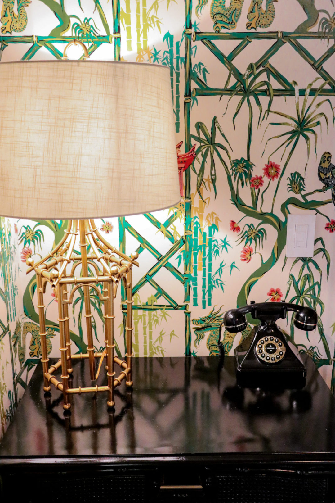 A Hollywood Regency style lamp and rotary phone on a bedside table in a Grand Premier room at The Prospect Hollywood in California, USA