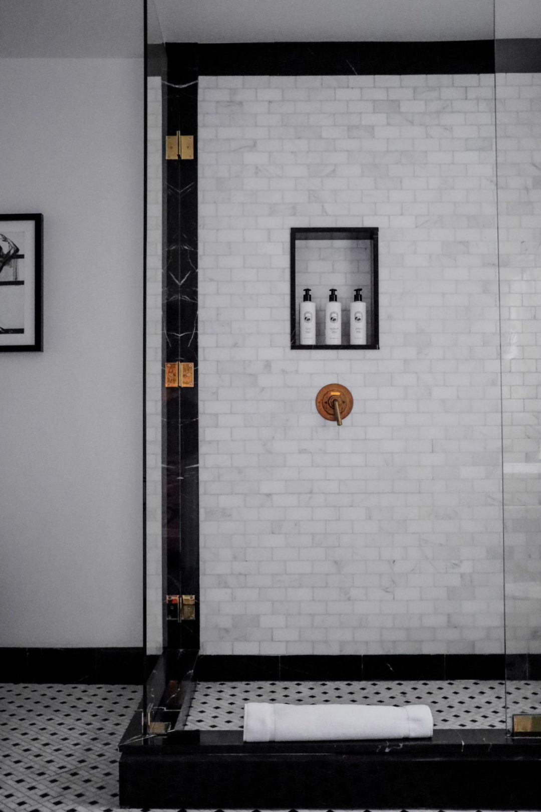 A marble and glass-encased shower inside with Diptyque soaps inside a Grand Premier Suite at The Prospect Hollywood in California, USA