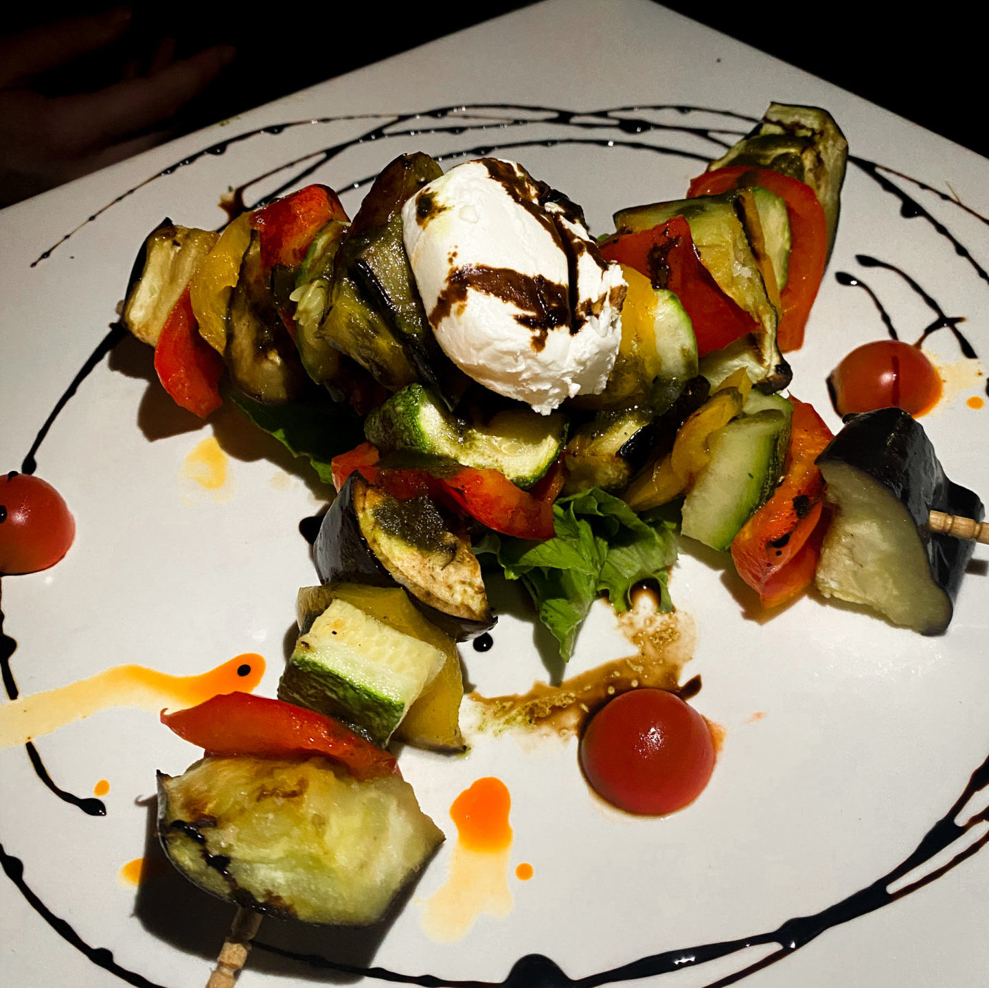 Vegetable skewers made of zucchini and peppers drizzled with balsamic vinaigrette