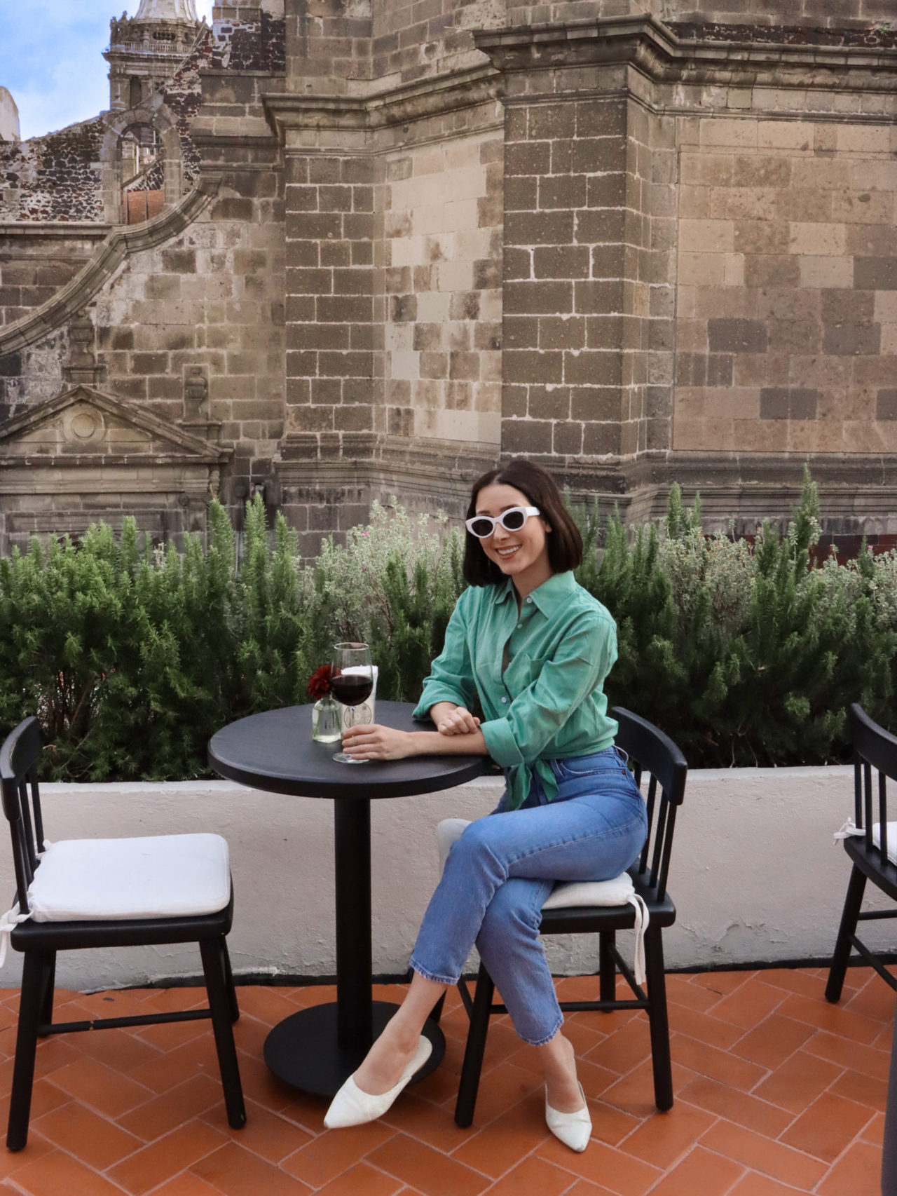 Natural Wine In Mexico City: Travel Blogger Jordan Gassner with a glass of red wine on the Circulo Mexicano rooftop above Caracol de Mar Restaurant