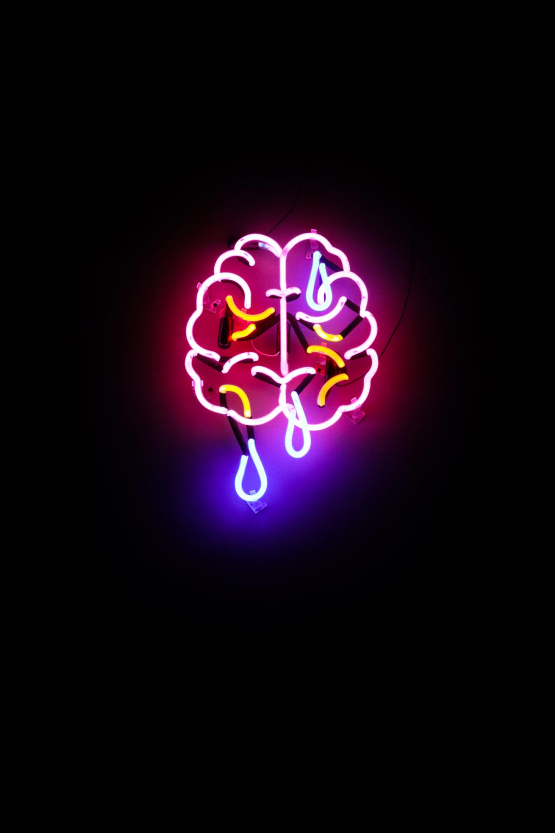 A light up neon sign showing a brain that looks like it's crying from Local 1 Bar in Mexico City