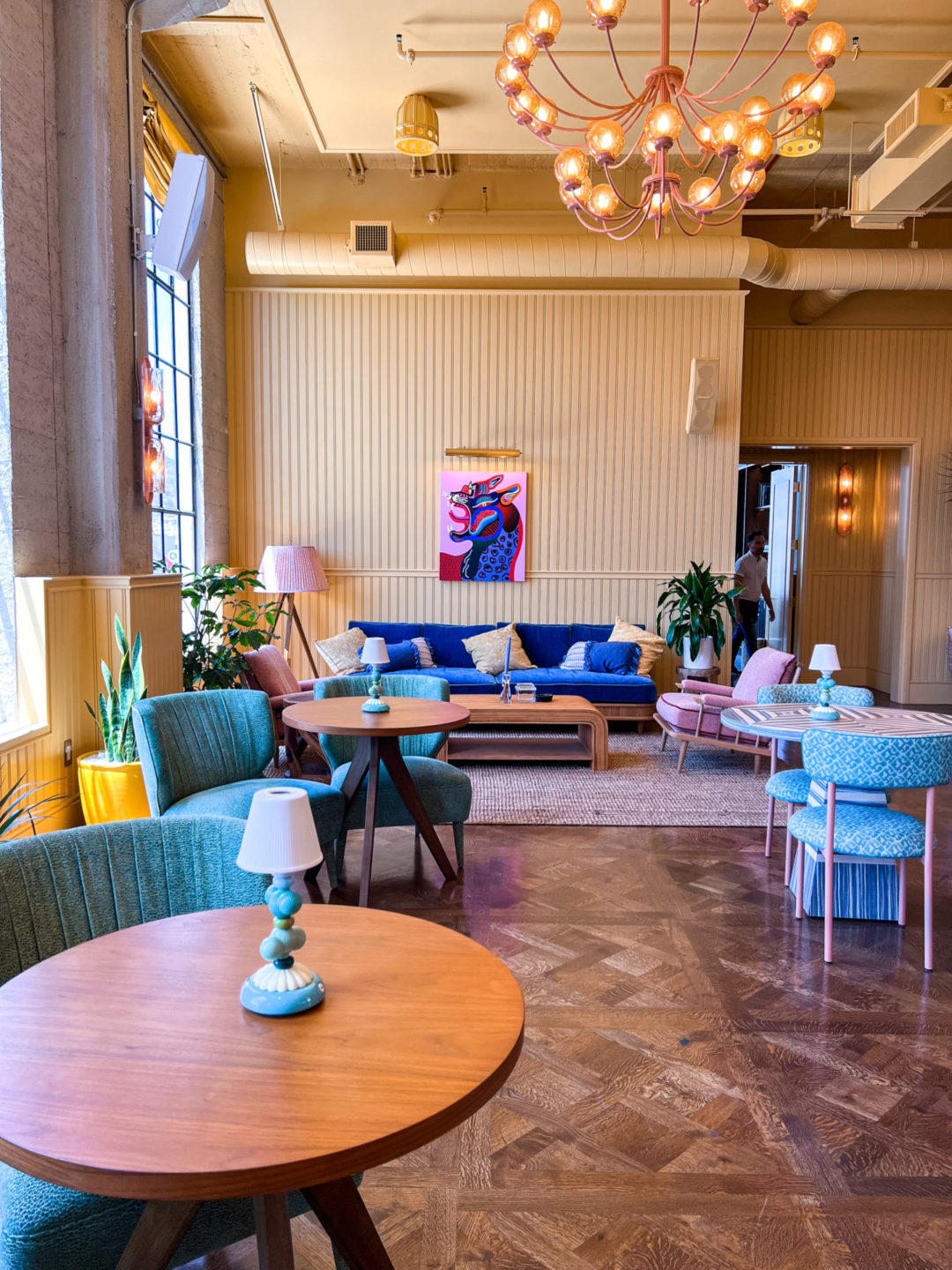 Heimat's pastel yellow and vibrant blue main coworking space as designed by Martin Brudnizki