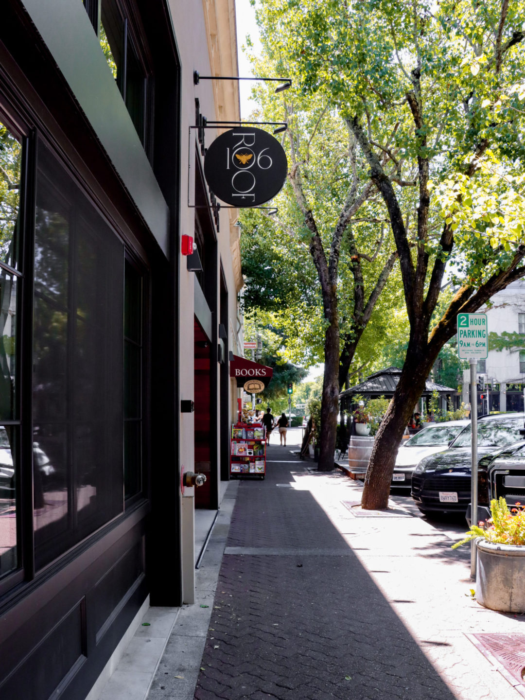 "Roof 106" and other signage topping the exterior of a row of shops and restaurants in Healdsburg, California