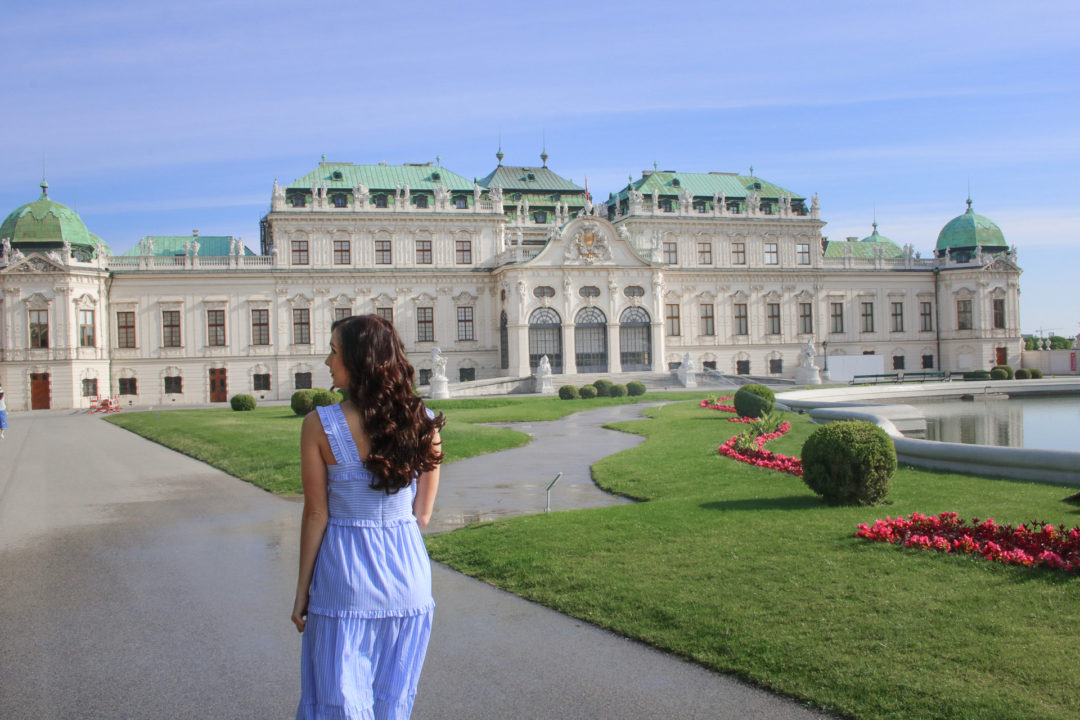 Travel Blogger Jordan Gassner walking through empty gardens in front of the Belvedere Museum in Vienna, Austria