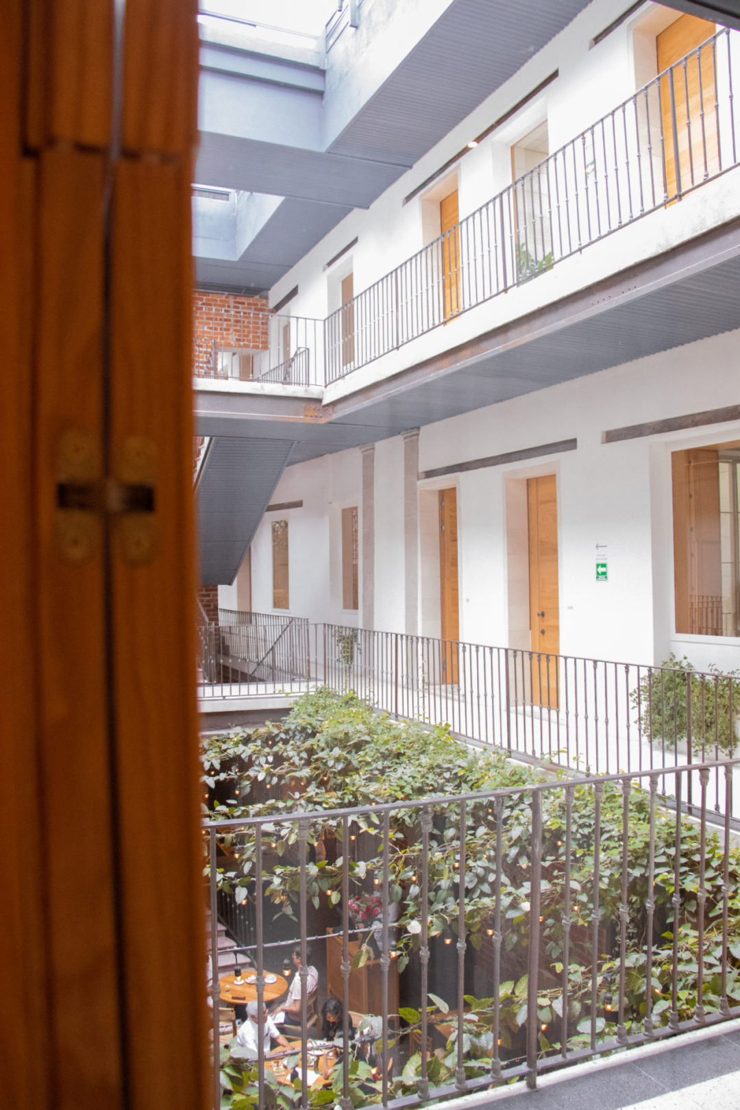 A window with an interior view of the Círculo Mexicano hotel in Mexico City