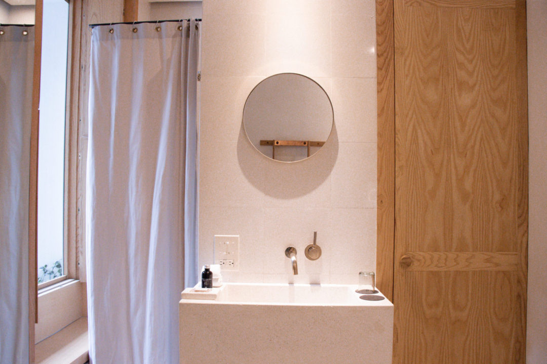 The bathroom sink and shower inside a Junior Suite at the Círculo Mexicano Boutique hotel in Mexico City