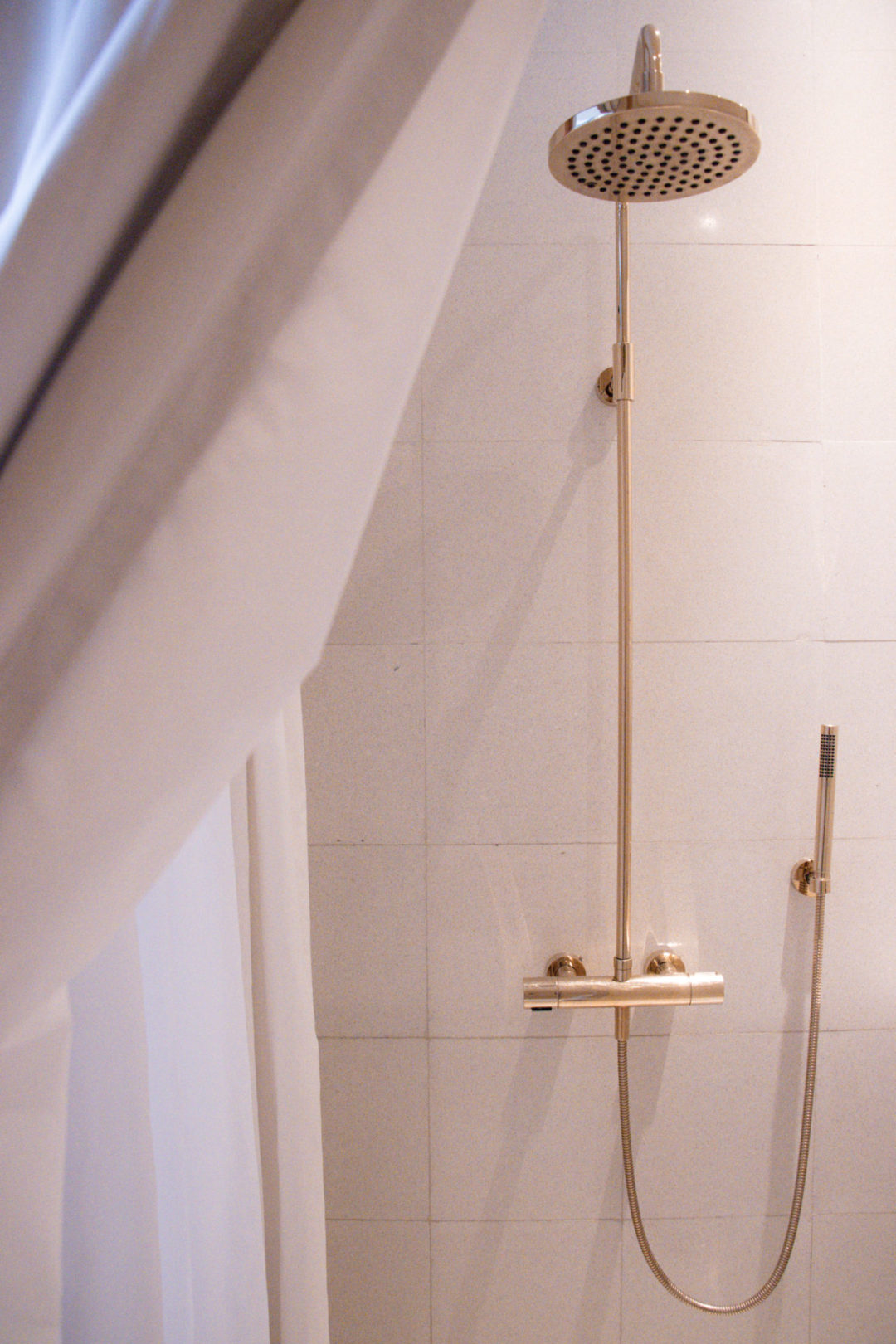 An in-room gold shower head at Círculo Mexicano Boutique hotel overlooking el Zocalo in Mexico City