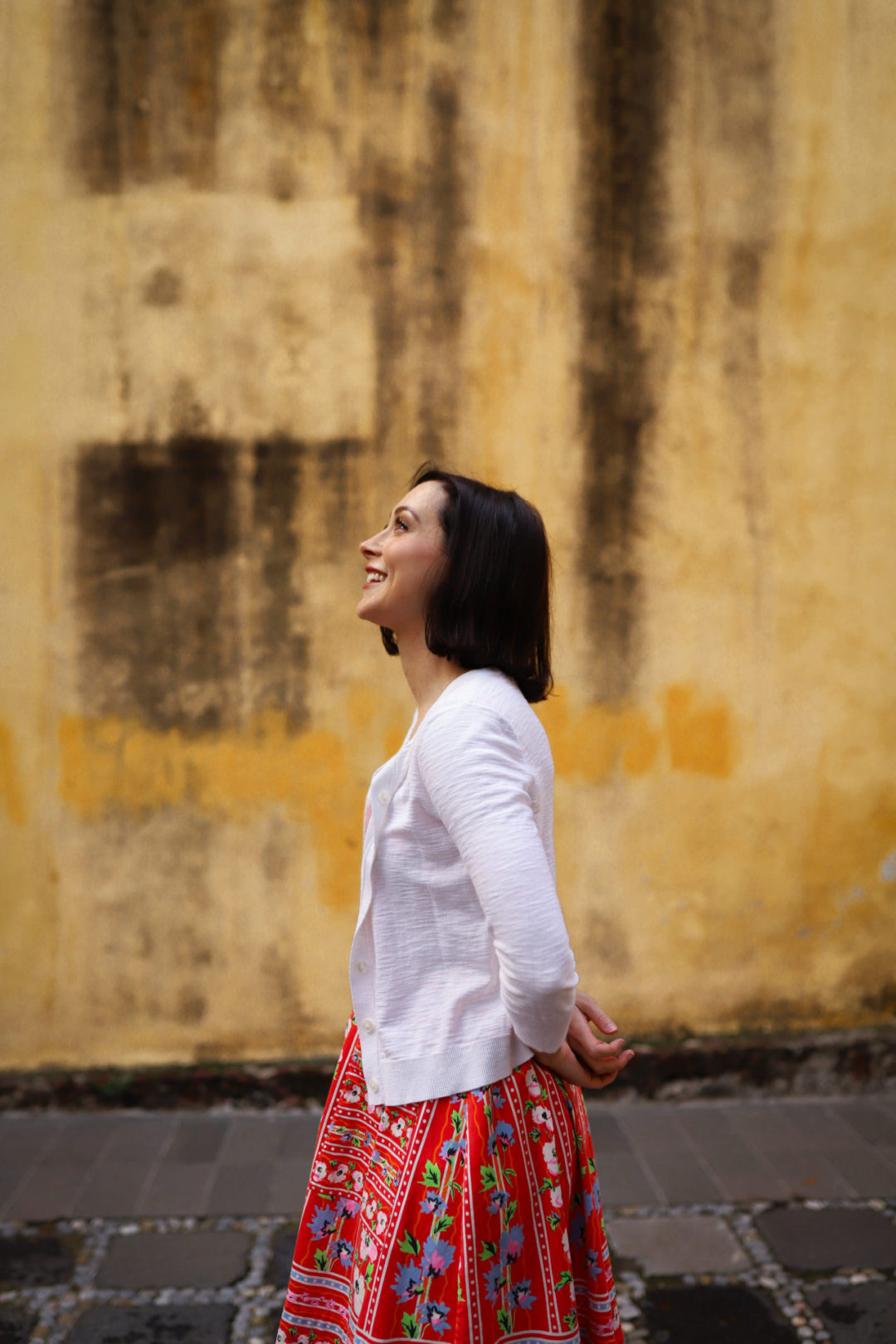 Travel Blogger Jordan Gassner smiling upwards near Capilla de La Conchita in Coyoacán Mexico City