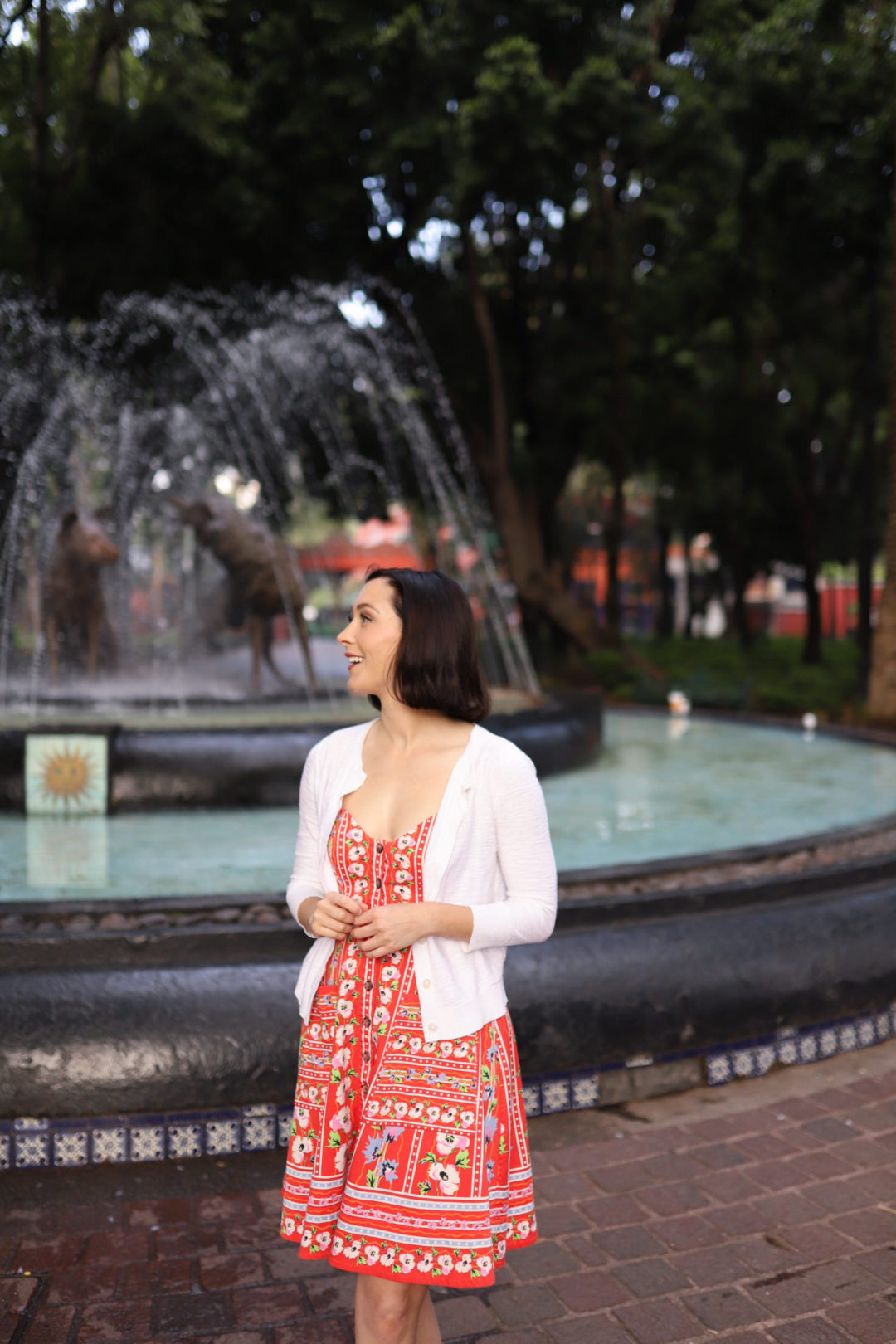 Travel Blogger Jordan Gassner glancing sideways and smiling at Fuente de los Coyotes in Coyoacán Mexico City