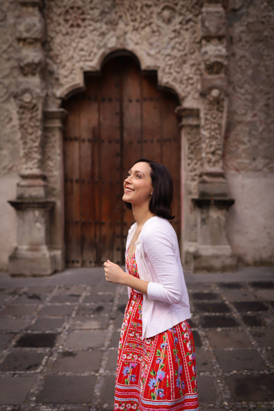 Travel Blogger Jordan Gassner smiling upwards in front of Capilla de La Conchita in Coyoacán Mexico City