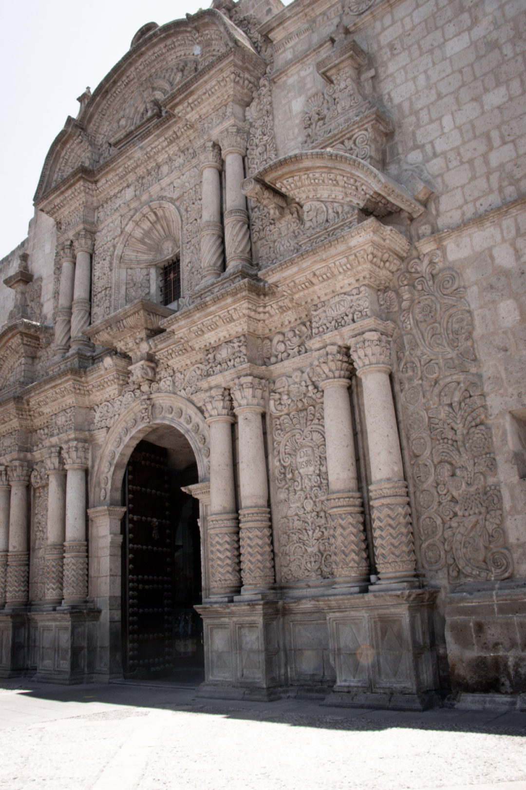 A sunny day in front of the detailed entrance of La Iglesia de la Compañía in Arequipa, Peru