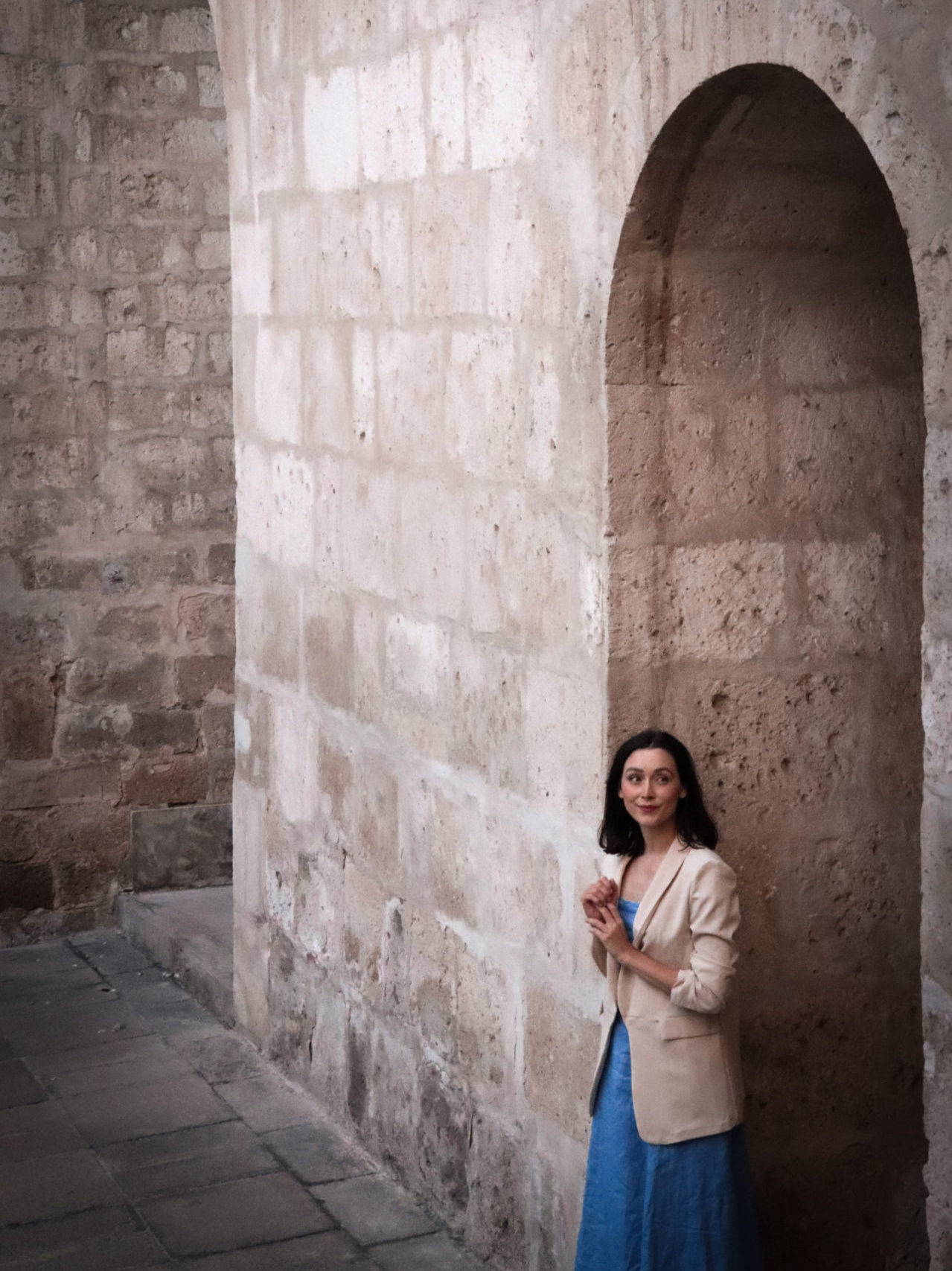 Travel Blogger Jordan Gassner standing near a sillar-based wall inside the Basilica Cathedral of Arequipa