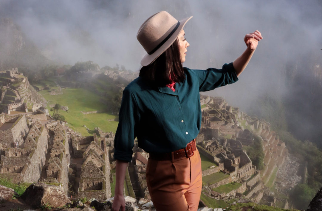 Travel Blogger Jordan Gassner taking a few tripod travel photos at a misty view point above Machu Picchu in Peru