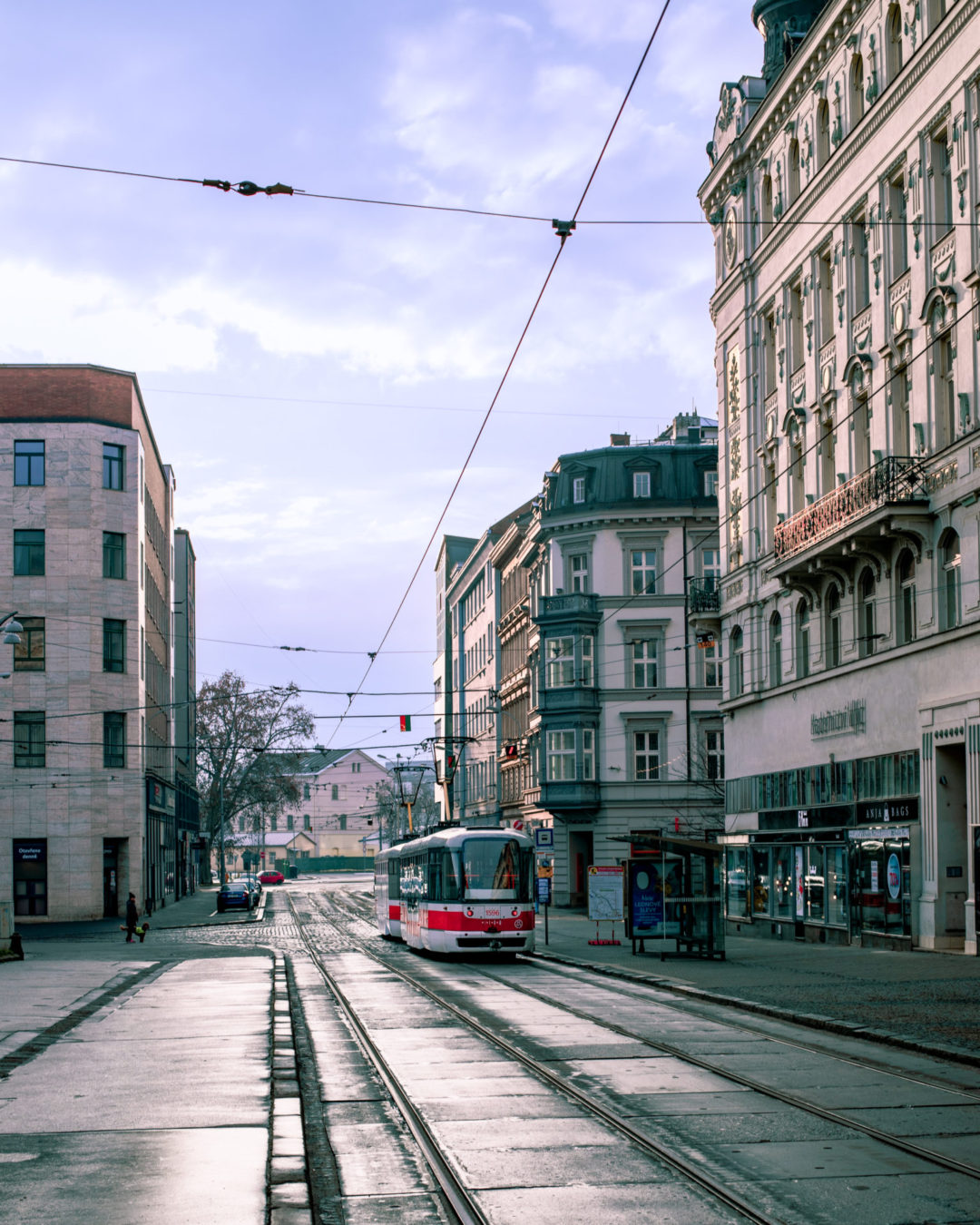 A mix of modern and historic architecture broken up by. anoncoming tram car throughout Brno's old town in Czechia