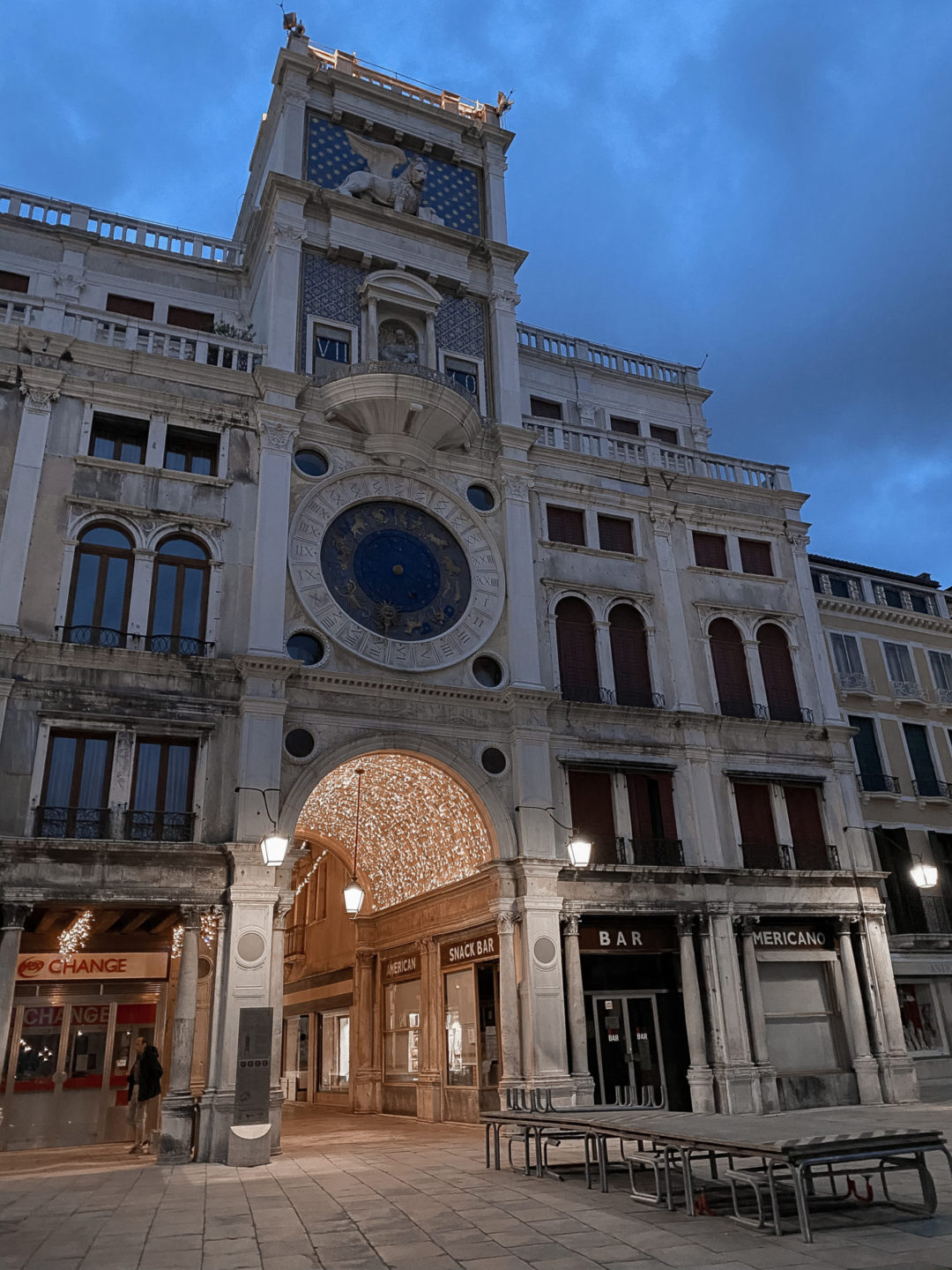 Venice's Torre dell'Orologio decorated with bright Christmas lights twinkling at twilight in Venice, Italy