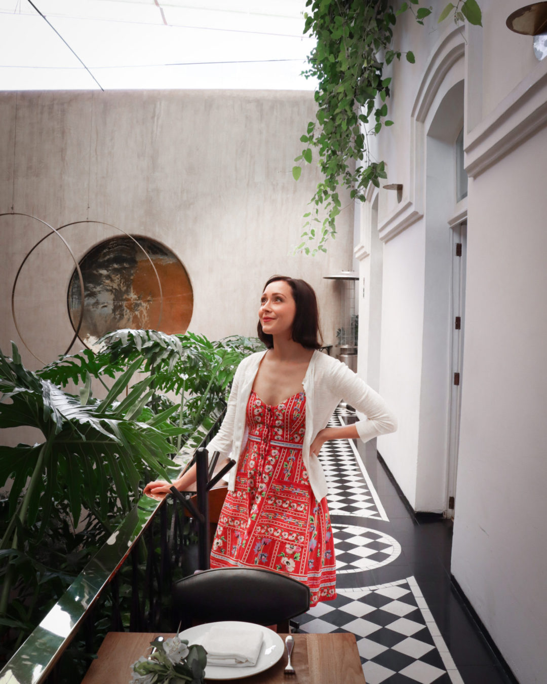 Travel Blogger Jordan Gassner staring out from the second floor balcony inside Blanco Colima in Roma Nte. Mexico City
