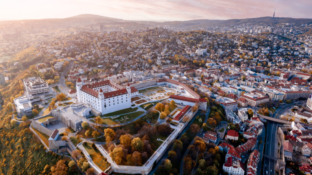 Bratislava Travel Guide: Bratislava Castle and all of Old Town bathed in golden light of a falling sun in the late afternoon