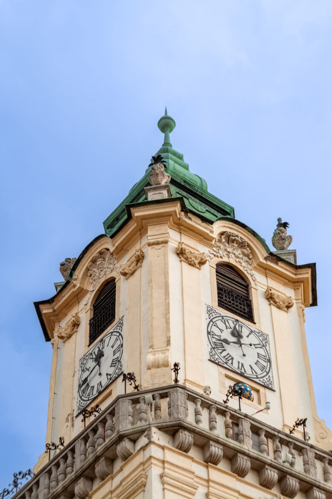 Bratislava Travel Guide: A view of. the Old Town Hall's yellow tower on a clear blue day