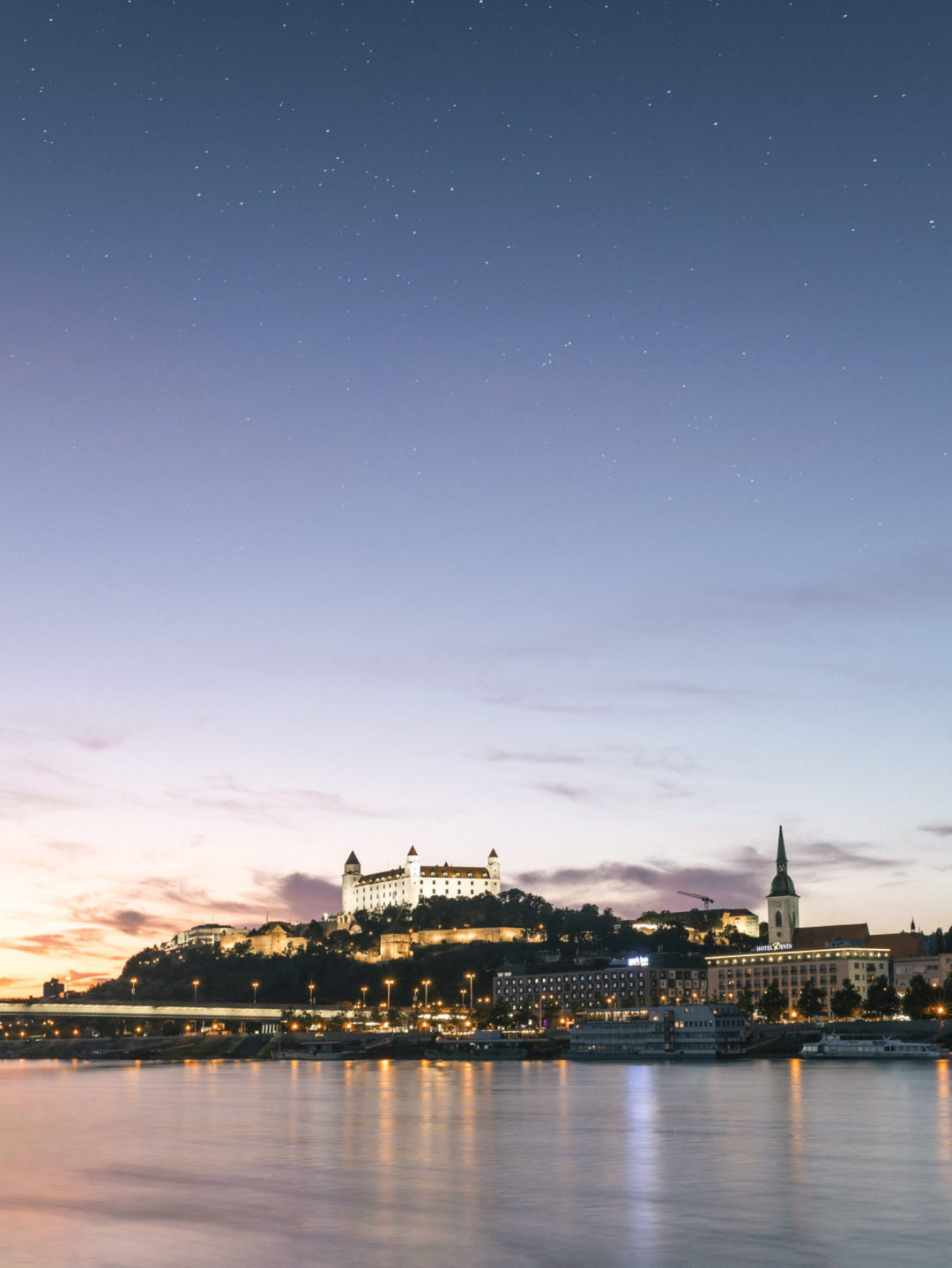 Bratislava Castle lit up as the sun is setting