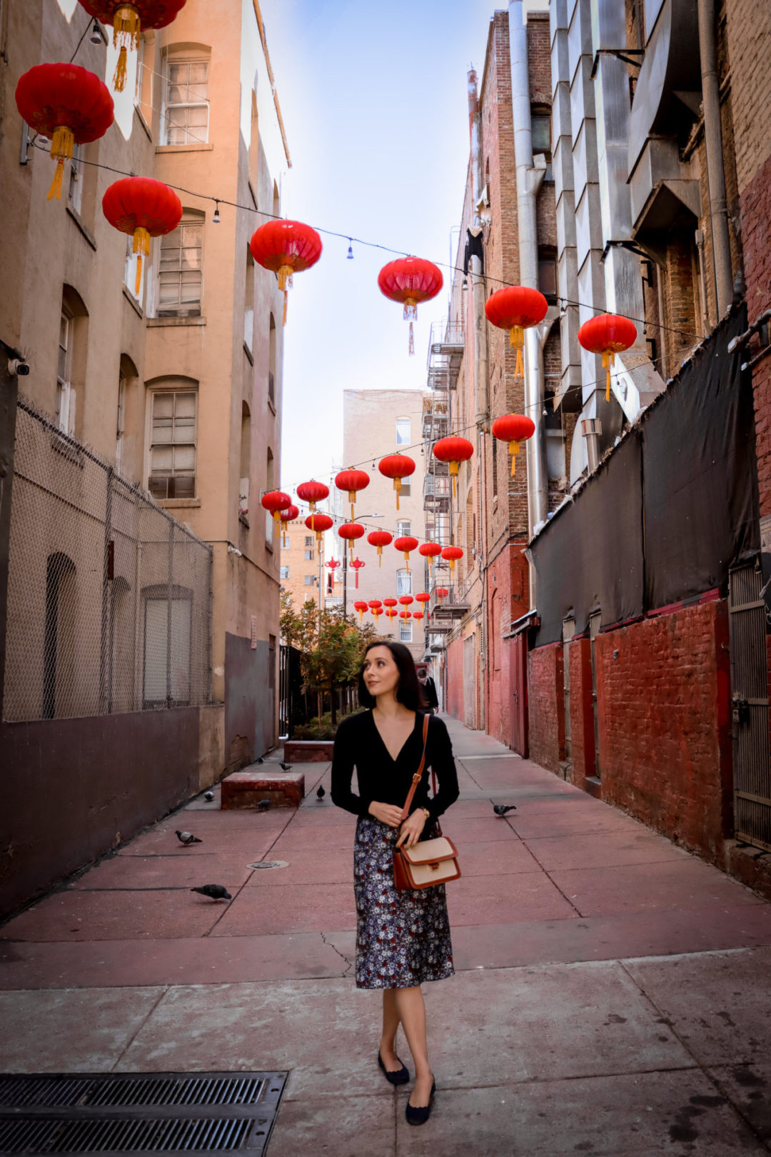 Travel Blogger Jordan Gassner walking down a lantern-strewn Hang Ah Street in San Francisco's Chinatown