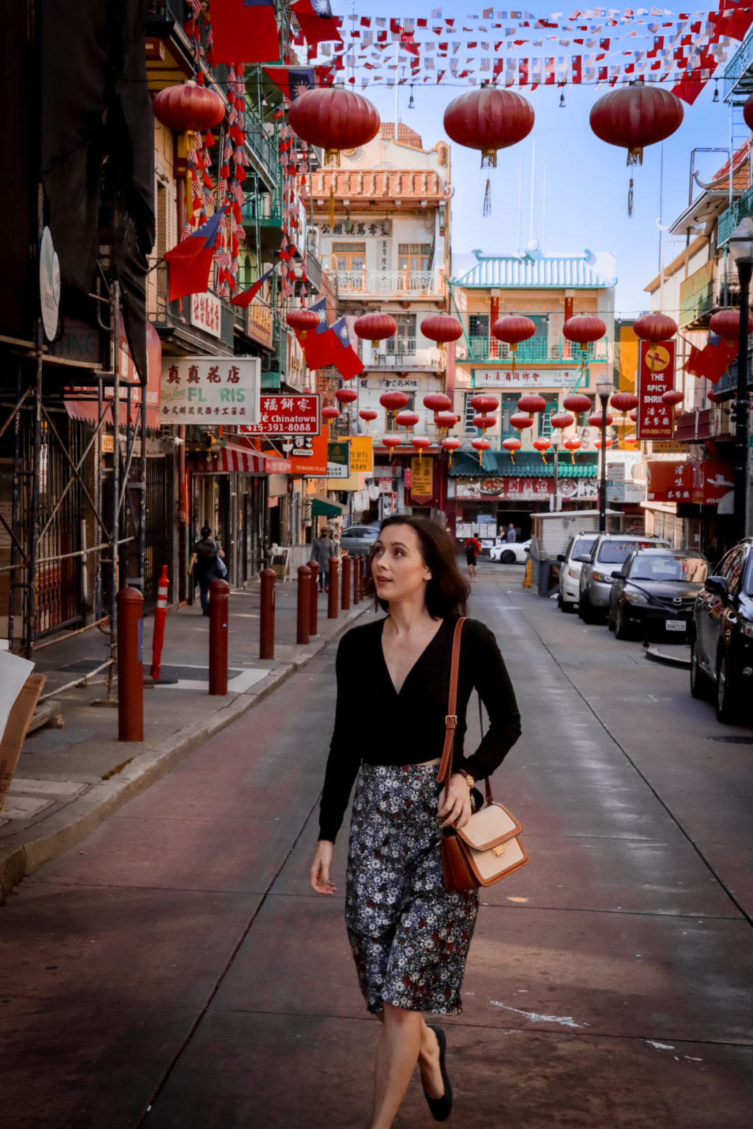 Travel Blogger Jordan Gassner looking up and walking along Waverly Place in San Francisco's Chinatown