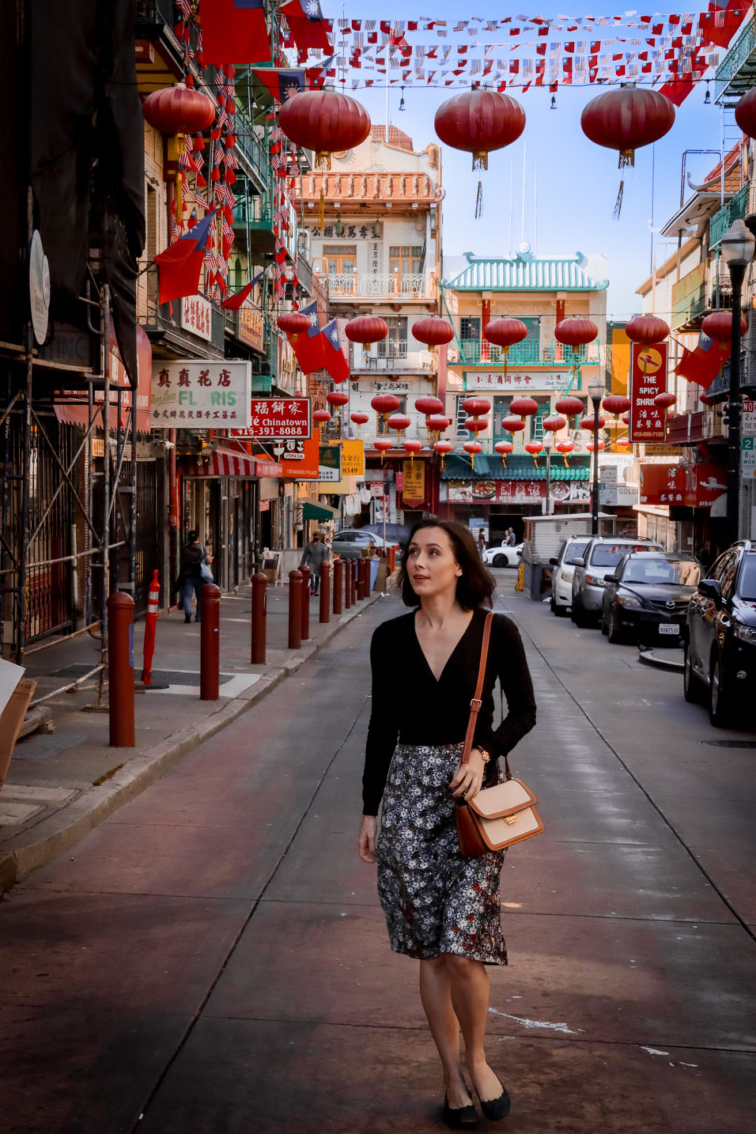 Travel Blogger Jordan Gassner looking to her right and walking along Waverly Place in San Francisco's Chinatown