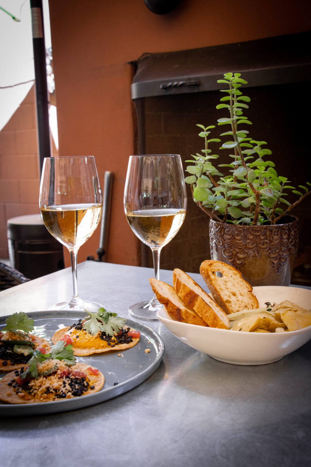 Two Glasses of White Wine, Black Lentil Tacos and Marinated Artichokes at Thomas Hill Organics Bistro and Wine Bar
