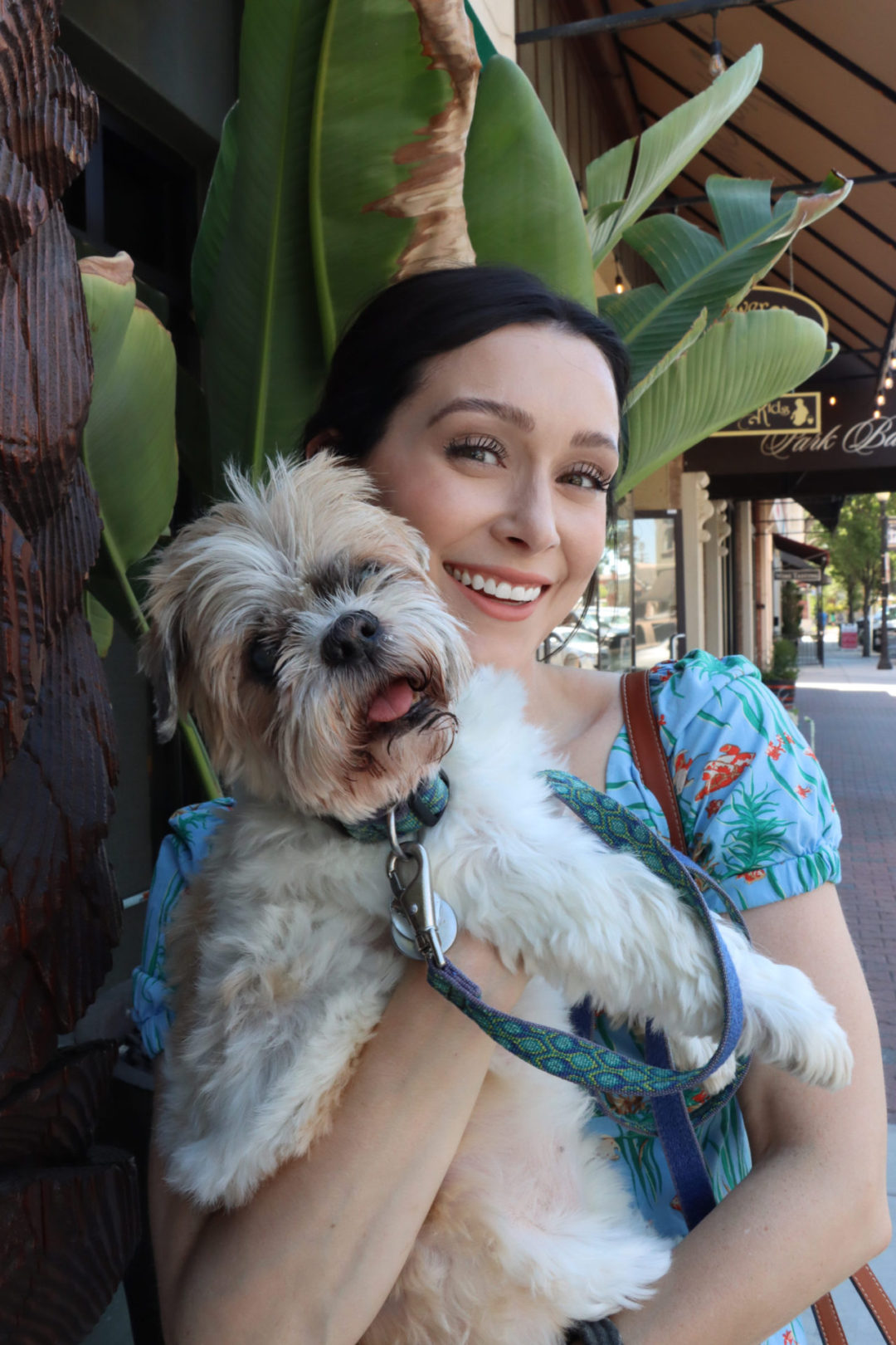 Travel Blogger Jordan Gassner smiling and holding her dog, Charlie, while spending one day in Paso Robles, California, USA